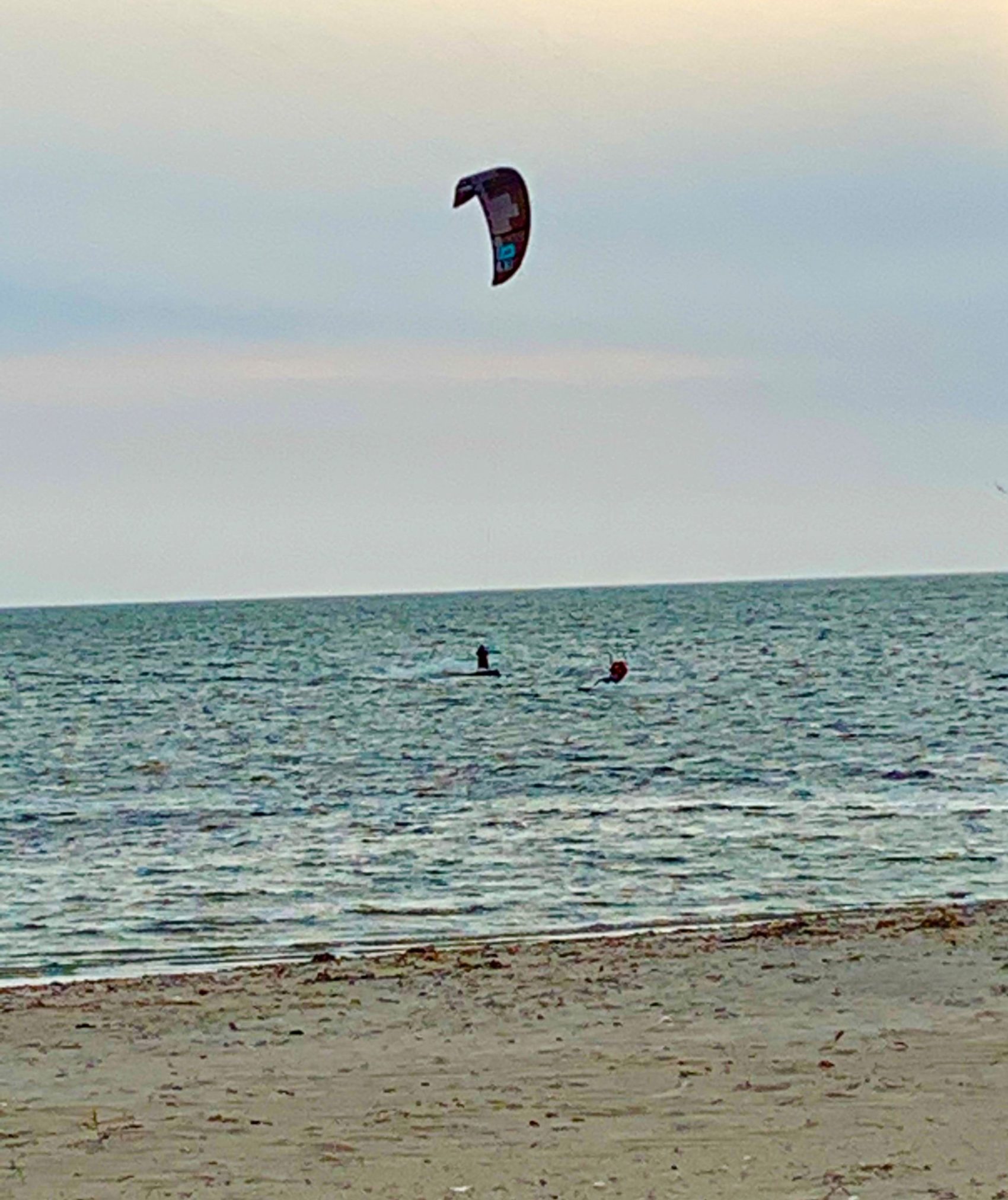 A person paragliding over the ocean